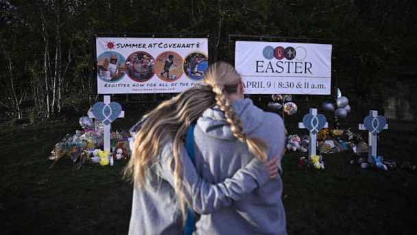 PHOTO: People embrace at a makeshift memorial for victims of a shooting at the Covenant School campus, in Nashville, Tenn., March 28, 2023. (Brendan Smialowski/AFP via Getty Images)