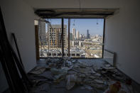 Damaged buildings are seen through the window of a room heavily damaged near the site of the Aug. 4 explosion that killed more than 170 people, injured thousands and caused widespread destruction, in Beirut, Lebanon, Friday, Aug. 14, 2020. (AP Photo/Hassan Ammar)