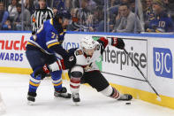 Arizona Coyotes forward Conor Garland (83) fends off St. Louis Blues center Justin Faulk (72) during the first period of an NHL hockey game Thursday, Feb. 20, 2020, in St. Louis. (AP Photo/Dilip Vishwanat)