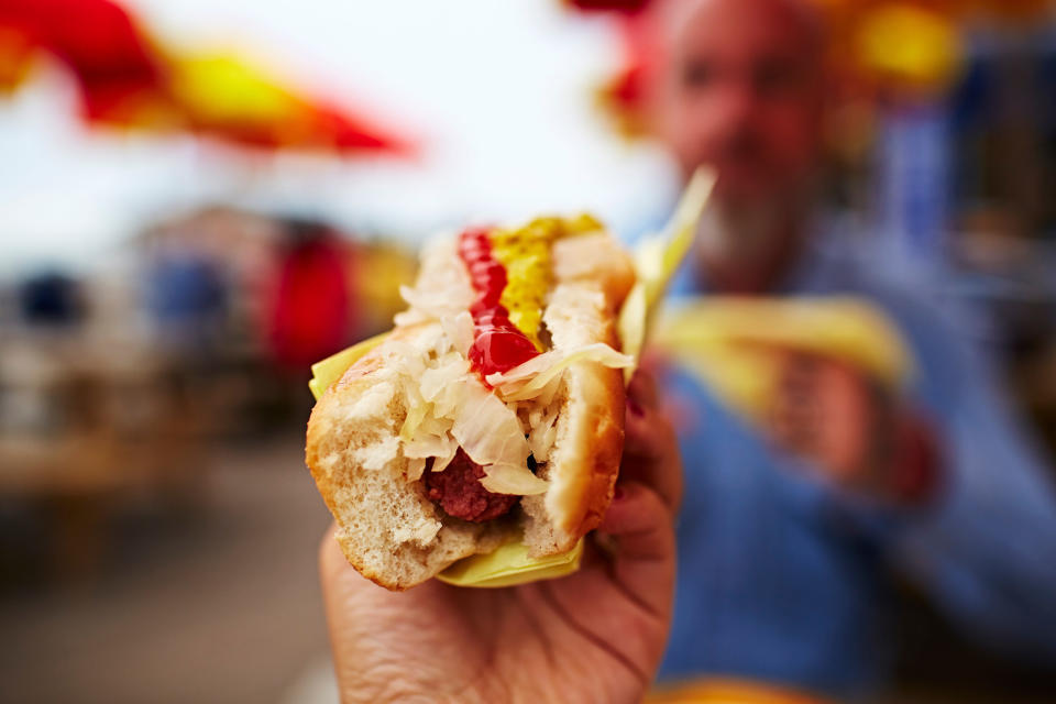 A hand holding a hot dog