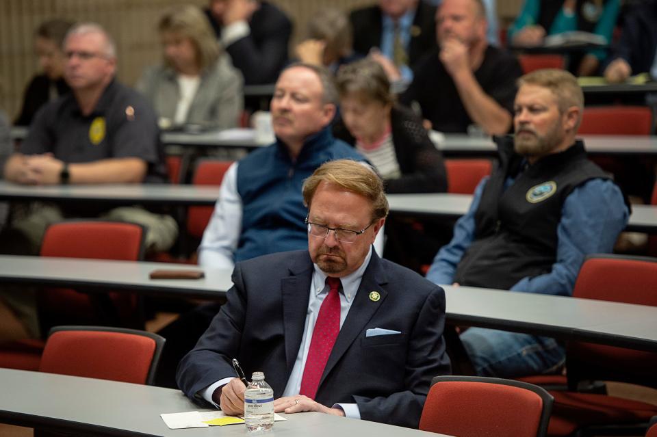 Congressman Chuck Edwards takes notes during a gathering of community leaders in light of the Canton paper mill closure at Haywood Community College March 10, 2023.