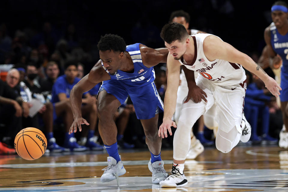 Memphis' Alex Lomax and Virginia Tech's Hunter Cattoor (0) scramble for the ball during the first half of an NCAA college basketball game in the NIT Season Tip-Off tournament Wednesday, Nov. 24, 2021, in New York. (AP Photo/Adam Hunger)