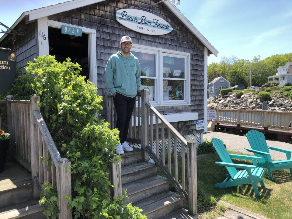 Michael DiSalvo is seen here on the front steps of his new shop, Beach Bum Threads, at Pekins Cove in Ogunquit, Maine, on May 18, 2023.