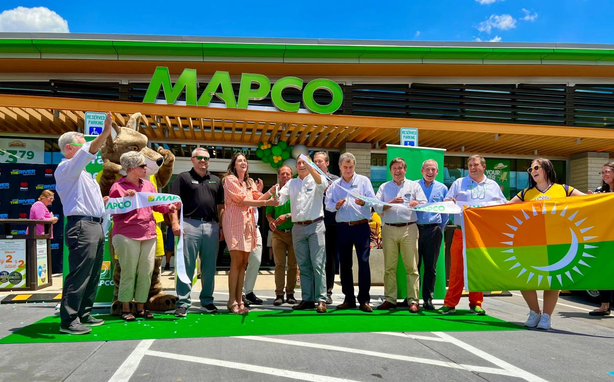MAPCO staff and Maury County leaders celebrate the opening of the gas station/convenience mart's new location at 2301 Carmack Blvd. with a ribbon cutting.