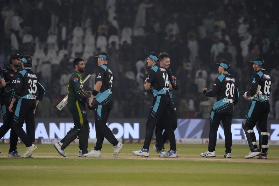 New Zealand's Michael Bracewell, center, shake hand with teammates on the end of play of the fourth T20 international cricket match between Pakistan and New Zealand, in Lahore, Pakistan, Thursday, April 25, 2024. (AP Photo/K.M. Chaudary)