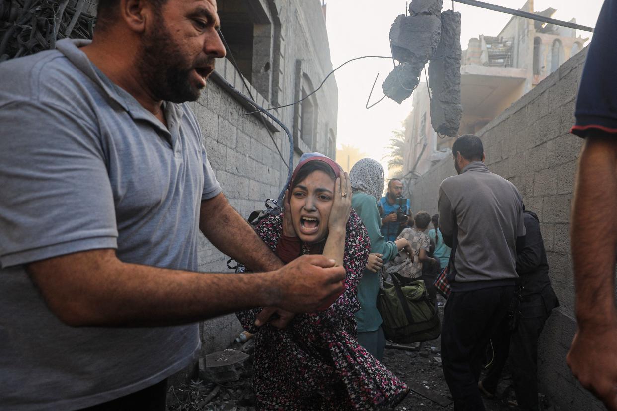 People flee following Israeli air strikes in the al-Maghazi refugee camp in Gaza, Nov. 6, amid ongoing battles between Israel and Hamas