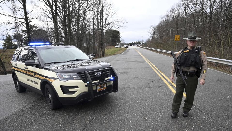 A Tennessee Highway Patrol trooper blocks the road to McGhee Tyson Air National Guard Base after reports were received of shots being fired Wednesday, Jan. 15, 2020, in Alcoa, Tenn. (AP Photo/Michael Patrick)