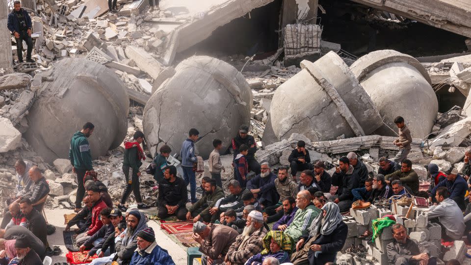 Palestinians perform the Friday noon prayers by the ruins of the al-Faruq mosque, destroyed by Israeli strikes in Rafah, in southern Gaza, on March 1. - Said Khatib/AFP/Getty Images