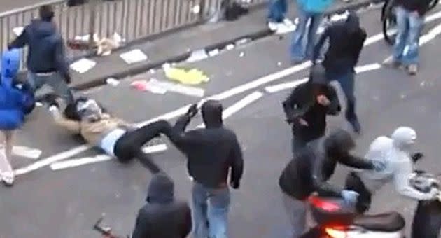 A mob tackles the scooterist while another looter makes off with the two-wheeler. Photo: YouTube