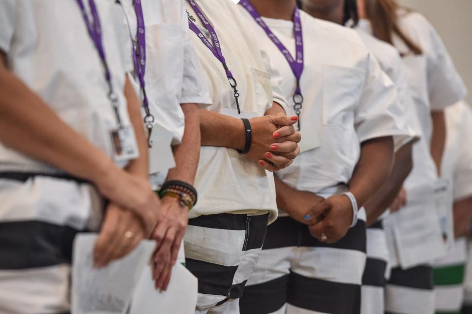 Seminary graduates take a moment of prayer during the dedication of the newly constructed chapel at the Mississippi Correctional Institute for Women (MCIW) at Central Mississippi Correctional Facility in Pearl, Miss., Thursday, June 15, 2023.