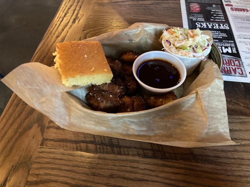 Pork belly burnt ends are served with coleslaw, cornbread and bourbon barbecue sauce at Wild Eagle in Streetsboro.