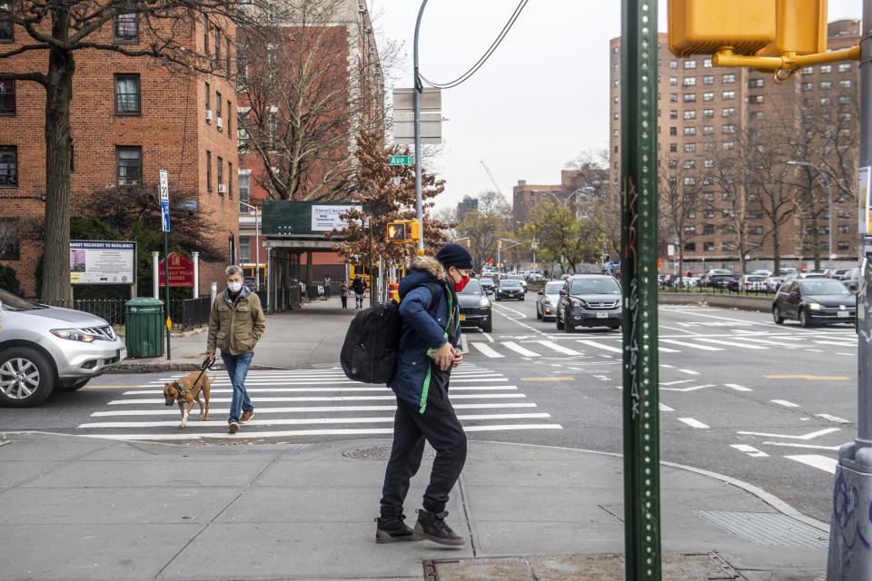 Students wear face masks while leaving school near Houston street on Tuesday, Dec. 21, 2021, in New York. (AP Photo/Brittainy Newman)