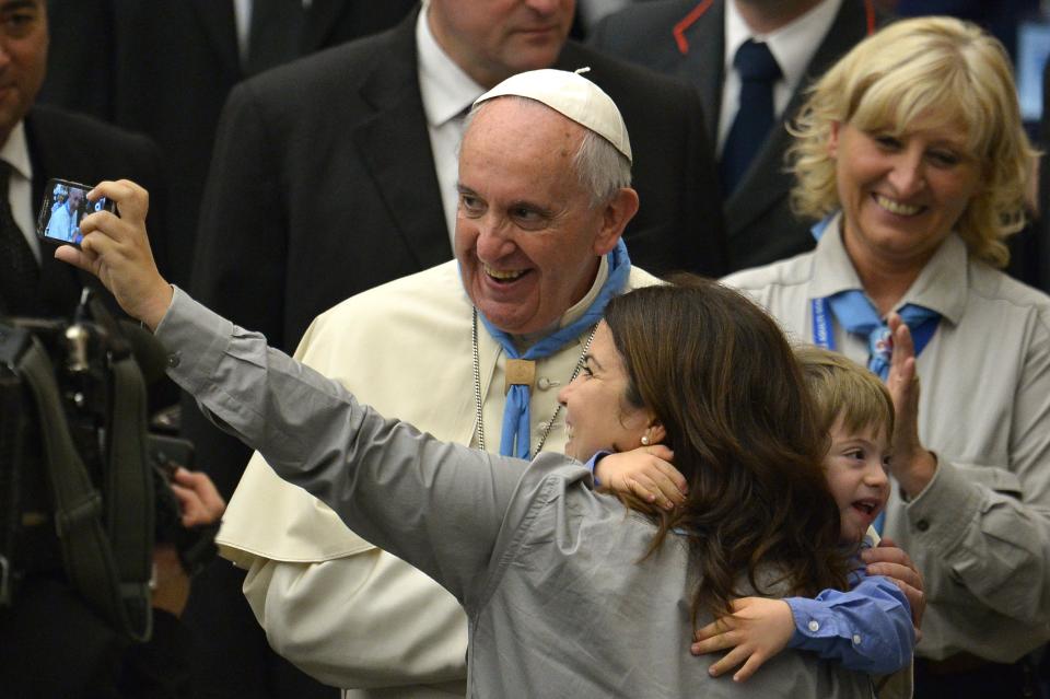 Pope Francis poses for a selfie during an audience with catholic Scouts at the Paul VI audience hall on November 8, 2014 at the Vatican.  AFP PHOTO / TIZIANA FABI        (Photo credit should read TIZIANA FABI/AFP/Getty Images)