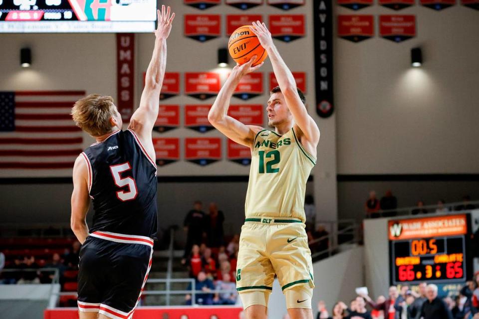 Charlotte 49ers guard Jackson Threadgill (12) shoots the game winning basket over Davidson Wildcats guard Grant Huffman (5) during a game at Belk Arena in Davidson, N.C., Tuesday, Nov. 29, 2022.