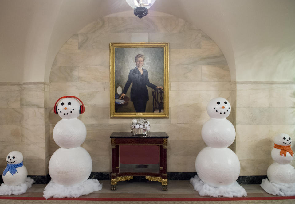 First Lady Hillary Clinton Smiles Beside Some Snowmen