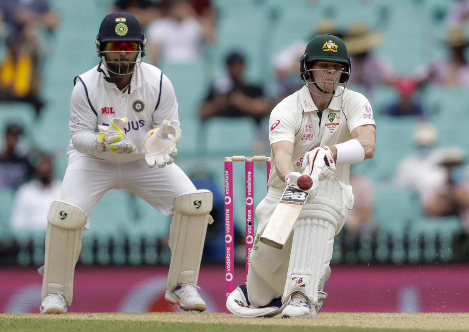 Australia's Steve Smith plays an unorthodox shot while batting during play on day two of the third cricket test between India and Australia at the Sydney Cricket Ground, Sydney, Australia, Friday, Jan. 8, 2021. (AP Photo/Rick Rycroft)