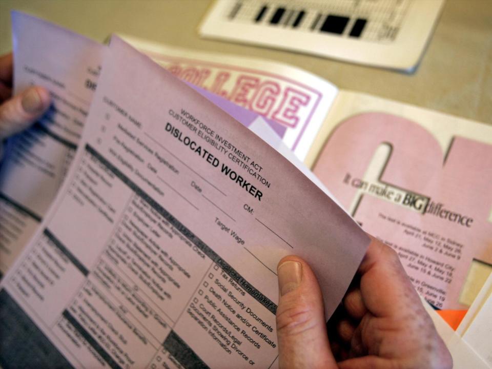 Unemployment papers held in hand, photo