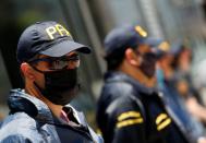 Police officers stand guard outside the building where Dr. Luque has his office in Buenos Aires