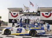 Chase Elliott (9) celebrates his victory in a NASCAR Cup Series auto race Sunday, July 4, 2021, at Road America in Elkhart Lake, Wis. (AP Photo/Jeffrey Phelps)