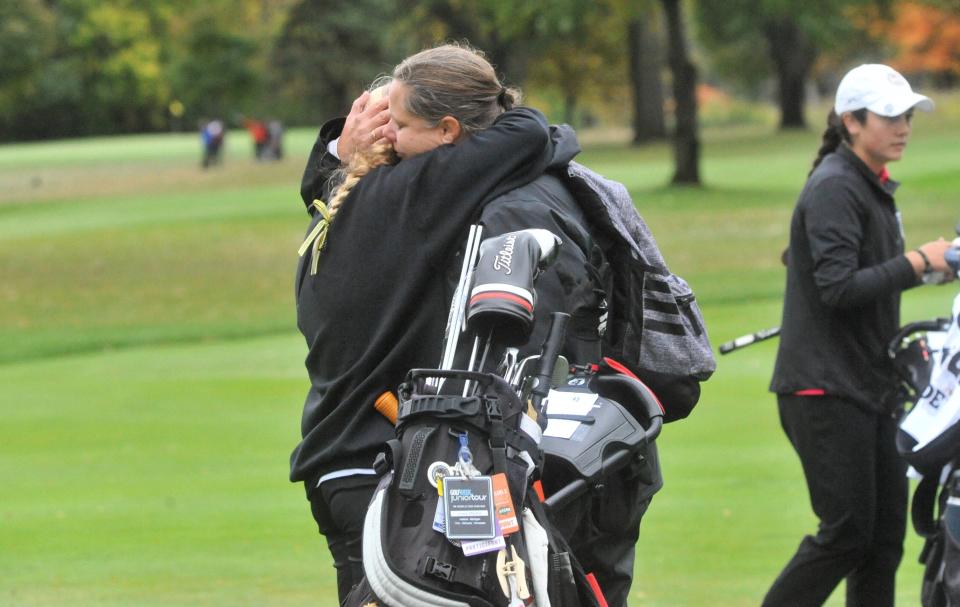 Colonel Crawford's Lucy Myers hugs her mother, and coach, Roni Halberg after coming off the green for the final time.