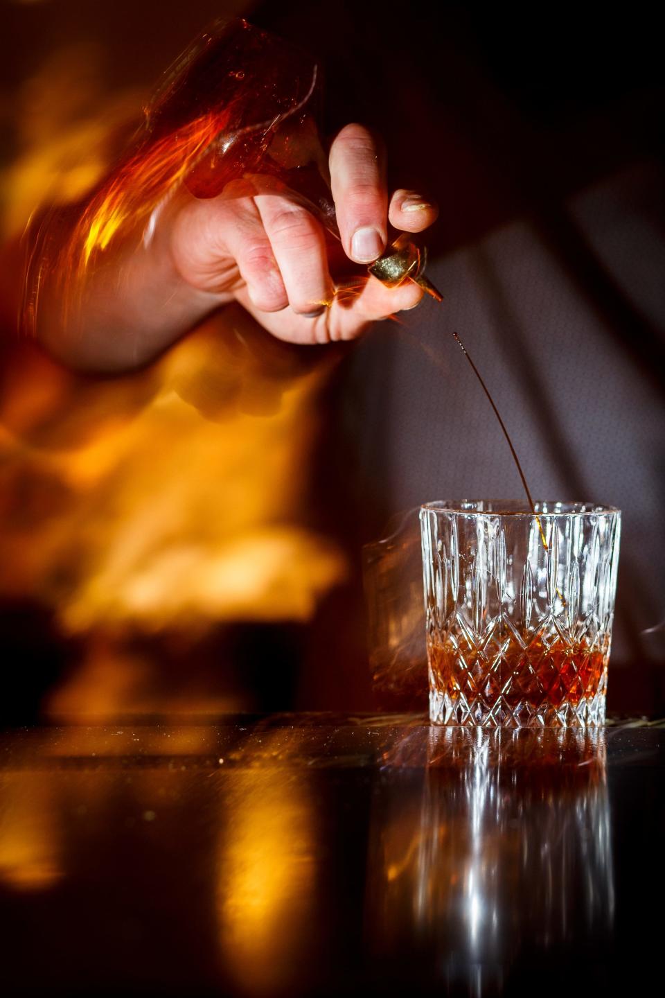 Jason Garnett pours cocktails at Juniper Moon on Friday, Feb. 26, 2021, in Des Moines. Garnett said at the worst the business was operating at about 20% of what it would normally do, but is now back up to about 40% thanks to an ease in restrictions.