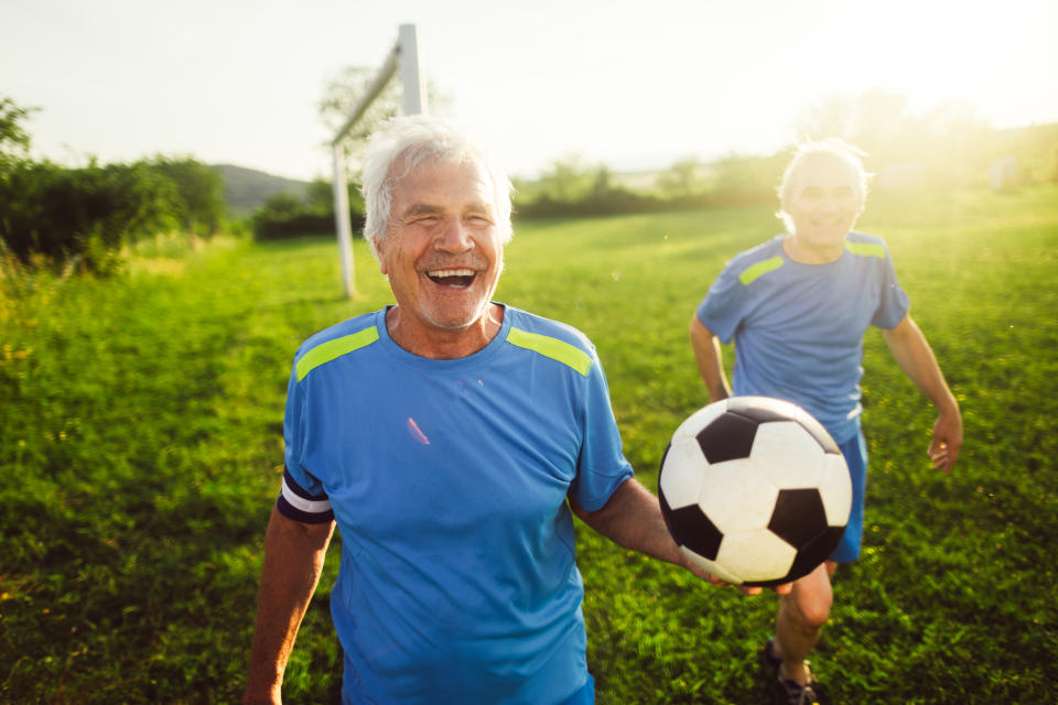 Portrait of smiling, senior soccer players