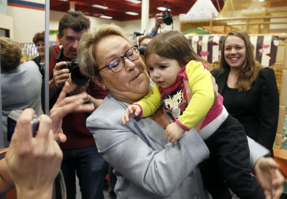 Parti Quebecois leader Pauline Marois holds a child at a children's indoor play centre in Blainville