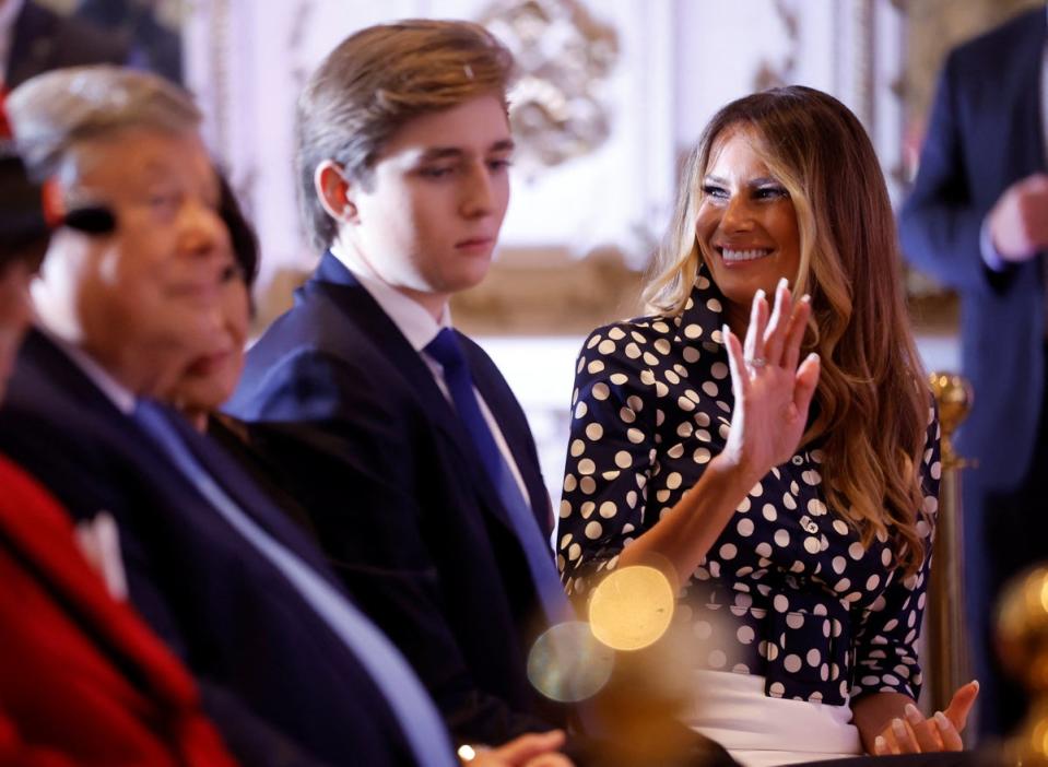 Ms Trump waves as she sits in the front row with son Barron Trump as her husband announces he will once again run for the presidency in 2024 on 15 November 2022 (REUTERS)