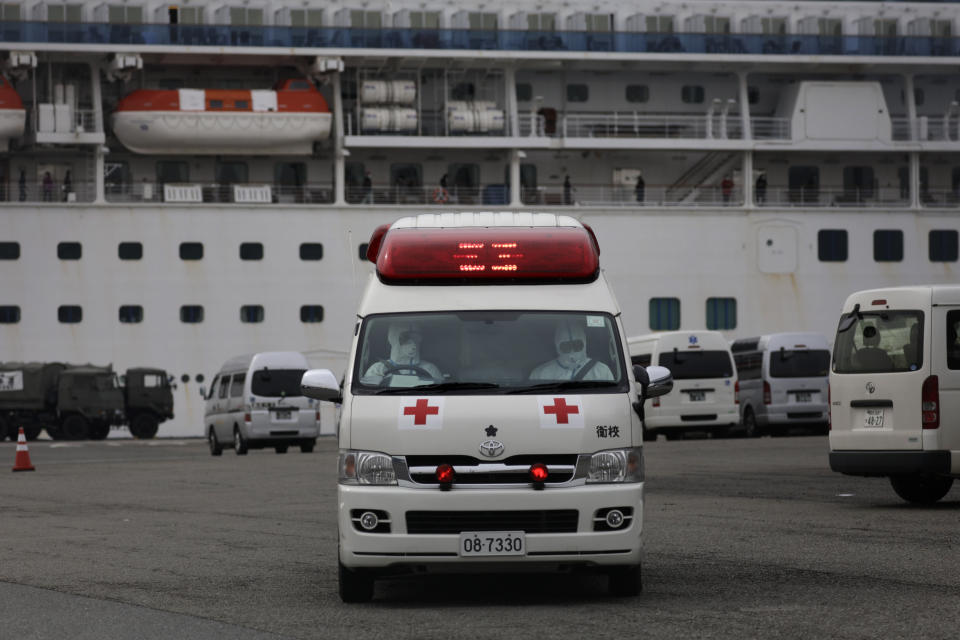 Medical workers wearing protective suits leave after tending to passengers on the quarantined Diamond Princess cruise ship Saturday, Feb. 15, 2020, in Yokohama, near Tokyo. A viral outbreak that began in China has infected more than 67,000 people globally. The World Health Organization has named the illness COVID-19, referring to its origin late last year and the coronavirus that causes it. (AP Photo/Jae C. Hong)