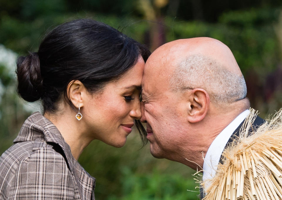 <p>Meghan performs a hongi as she attends a traditional welcome ceremony on the lawns of Goverment House in New Zealand on the royal tour (Getty) </p>