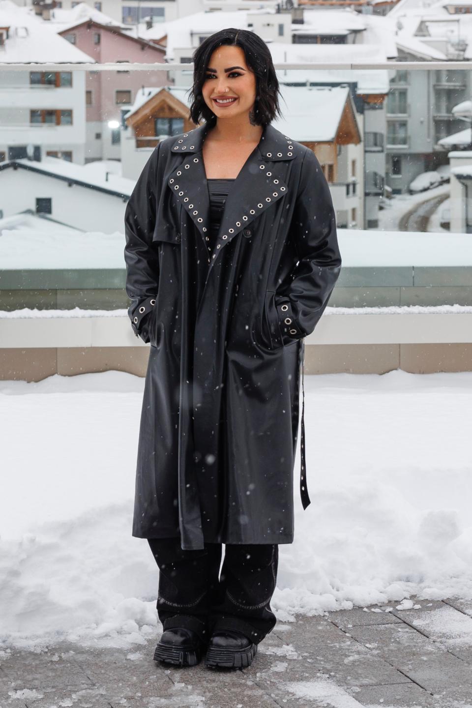 Demi Lovato, boots, black boots, winter boots, thick sole boots, round toe boots, coat, leather coat, eyelet coat, studded coat, puffer jacket, puffer coat, black coat, concert, music, musicians,  winter, winter style, Austria