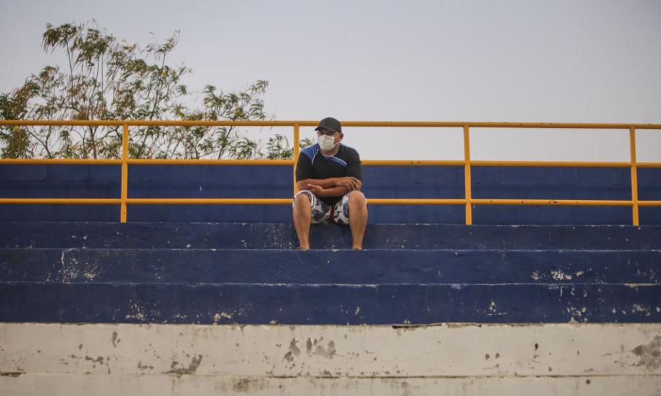 A fan with a face mask watches Managua take on Diriangén.