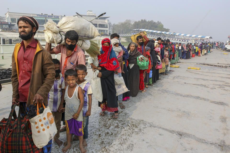 FILE - IN this Feb. 15, 2021, file photo, Rohingya refugees headed to the Bhasan Char island prepare to board navy vessels from the south eastern port city of Chattogram, Bangladesh. The United Nations said Wednesday, Feb. 24, 2021, that a group of Rohingya refugees is adrift in a boat in the Andaman Sea without food or water, and that their families are worried that many may have already died. (AP Photo, File)