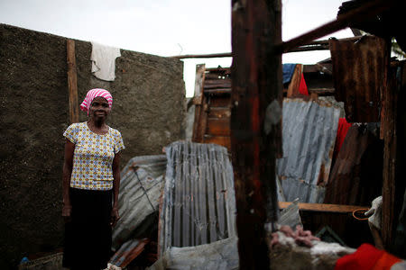Rose-Marie Edmond, 74, poses for a photograph in her destroyed house after Hurricane Matthew hit Jeremie, Haiti, October 16, 2016. "I have no place to live, all my house is gone. I'm sleeping in a shelter and I haven't the strength to start again," said Edmond. REUTERS/Carlos Garcia Rawlins