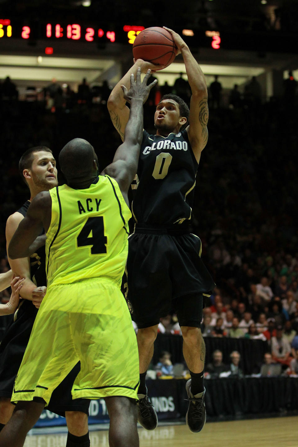 ALBUQUERQUE, NM - MARCH 17: Askia Booker #0 of the Colorado Buffaloes shoots against Quincy Acy #4 of the Baylor Bears in the second half of the game during the third round of the 2012 NCAA Men's Basketball Tournament at The Pit on March 17, 2012 in Albuquerque, New Mexico. Baylor won 80-63 in regualtion. (Photo by Ronald Martinez/Getty Images)