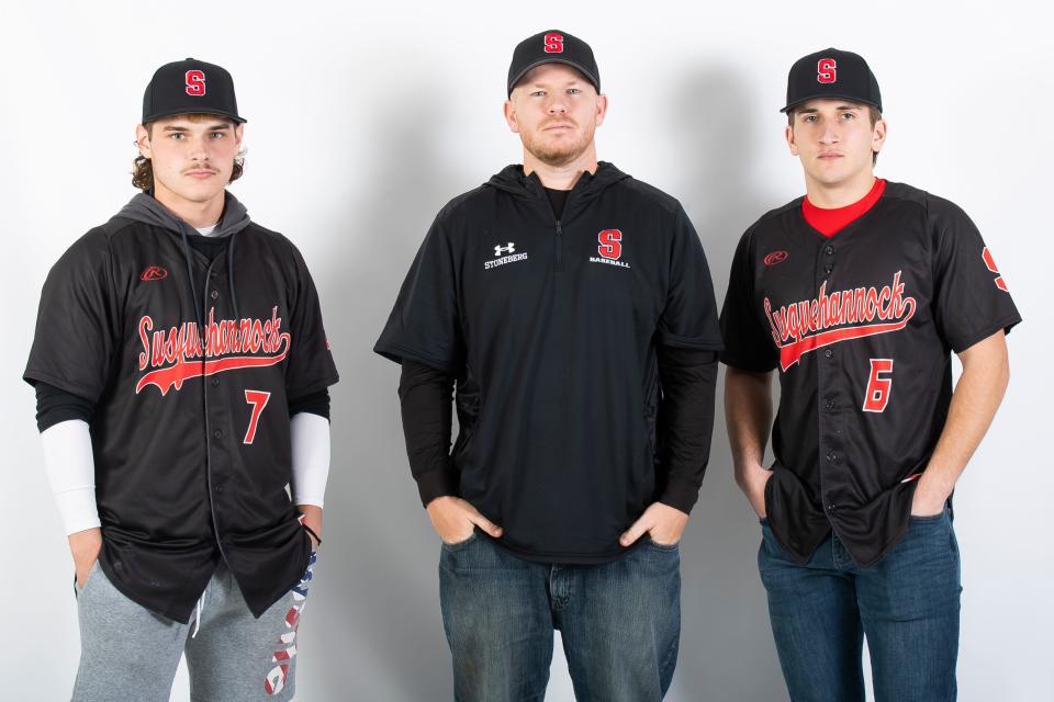 Susquehannock baseball head coach Joel Stoneberg poses for a photo with players Luke Geiple (7) and Ben Koller (6) during YAIAA spring sports media day on Feb. 27, 2023, in York.