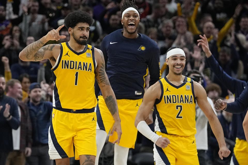 Indiana Pacers' Obi Toppin (1), Myles Turner and Andrew Nembhard (2) celebrate after the Pacers defeated the Phoenix Suns in an NBA basketball game Friday, Jan. 26, 2024, in Indianapolis. (AP Photo/Darron Cummings)