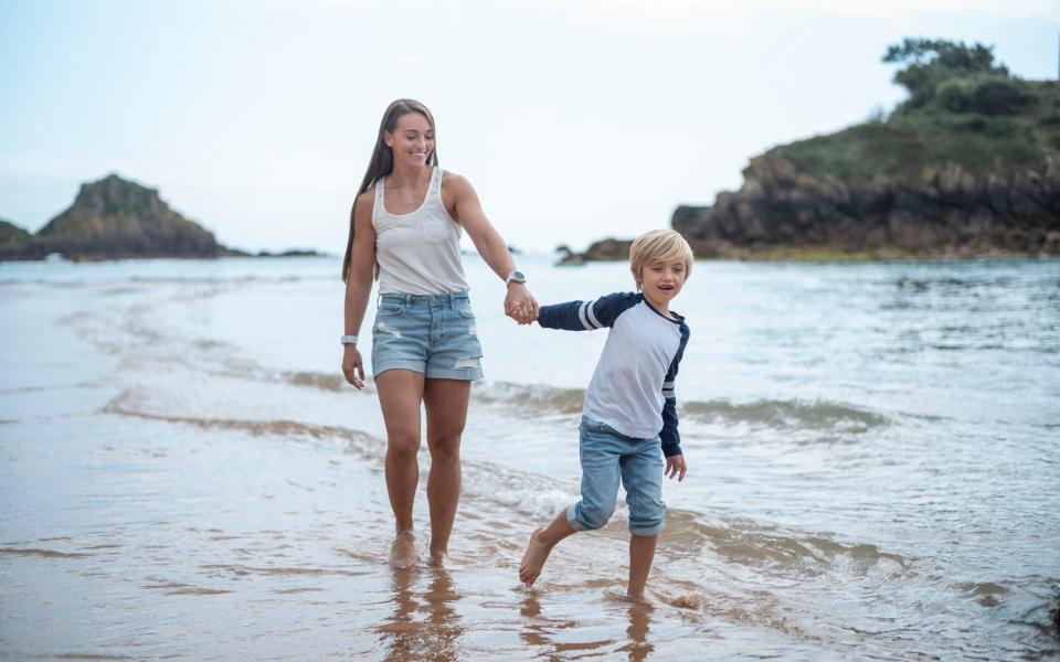 Jade Knight playing with her son on the beach near their Jersey home - David Rose