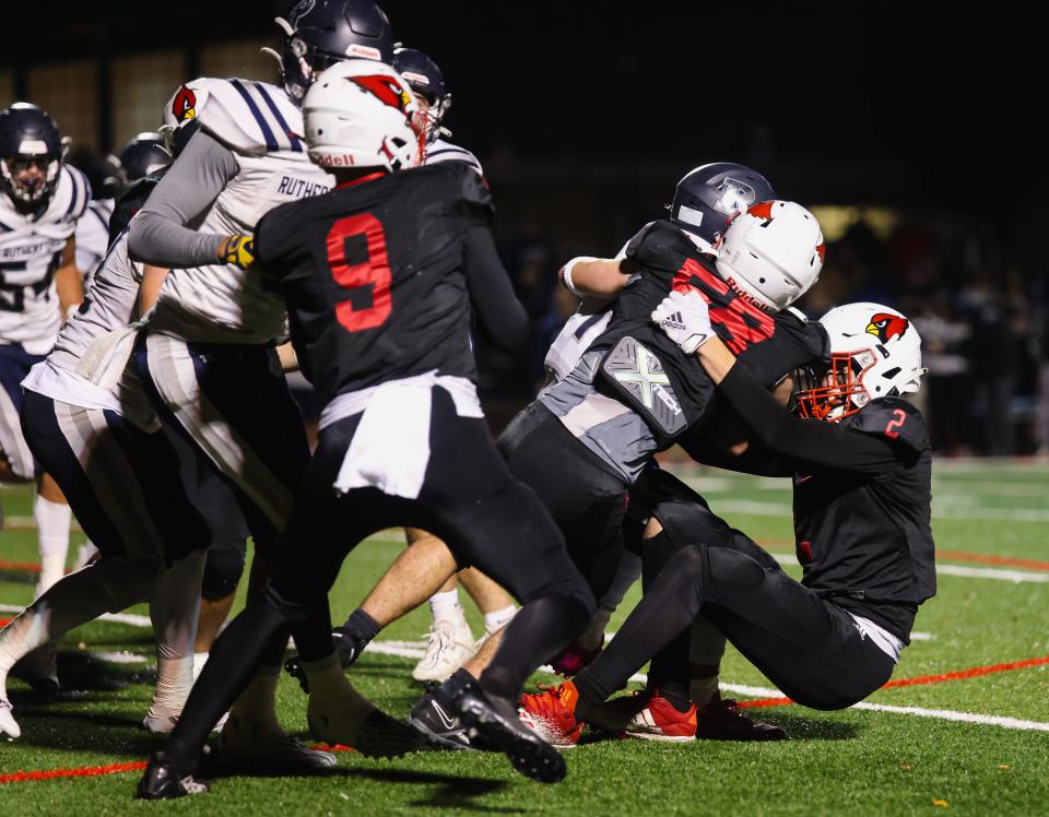 Westwood LBs Luke Bussanich (2) and Michael Carcich converge to tackle the Rutherford ball carrier.