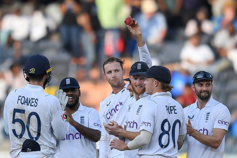 Tom Hartley (C) claimed seven wickets in India's second innings to help England to victory in the first Test in Hyderabad (Noah SEELAM)