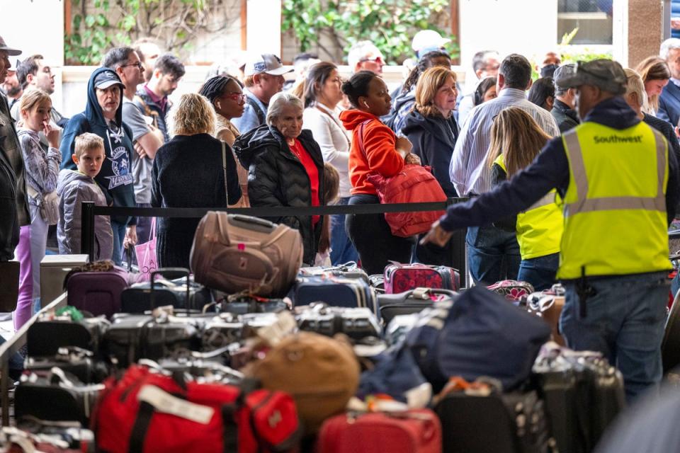 People wait to retrieve their luggage at Hollywood Burbank Airport in California (Hans Gutknecht/The Orange County Register/AP)