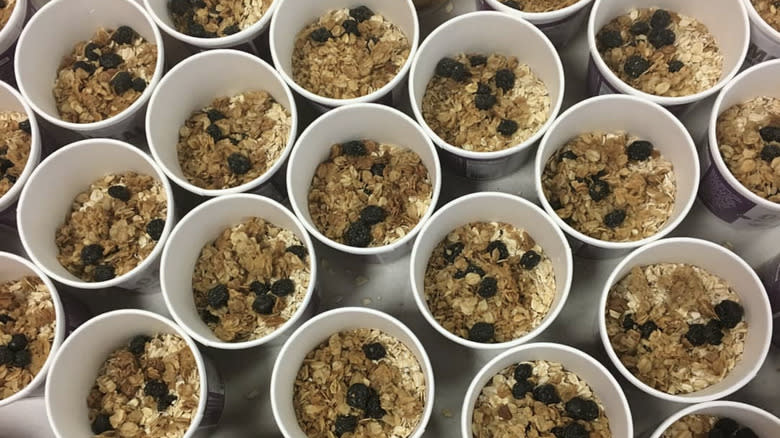 Cups of dry instant oatmeal with dried blueberries