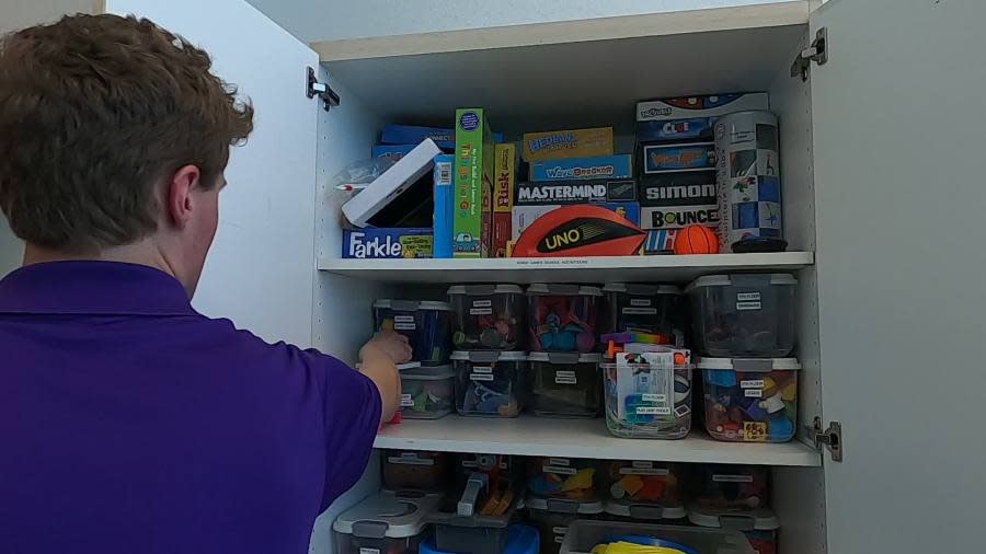 Volunteer Porter Beilfuss helps tidy up in the playroom at Helen DeVos Children's Hospital in Grand Rapids. (April 2024)