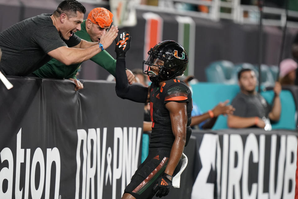 Miami wide receiver Charleston Rambo celebrates with fans after a touchdown run during the second half of the team's NCAA college football game against North Carolina State, Saturday, Oct. 23, 2021, in Miami Gardens, Fla. (AP Photo/Wilfredo Lee)