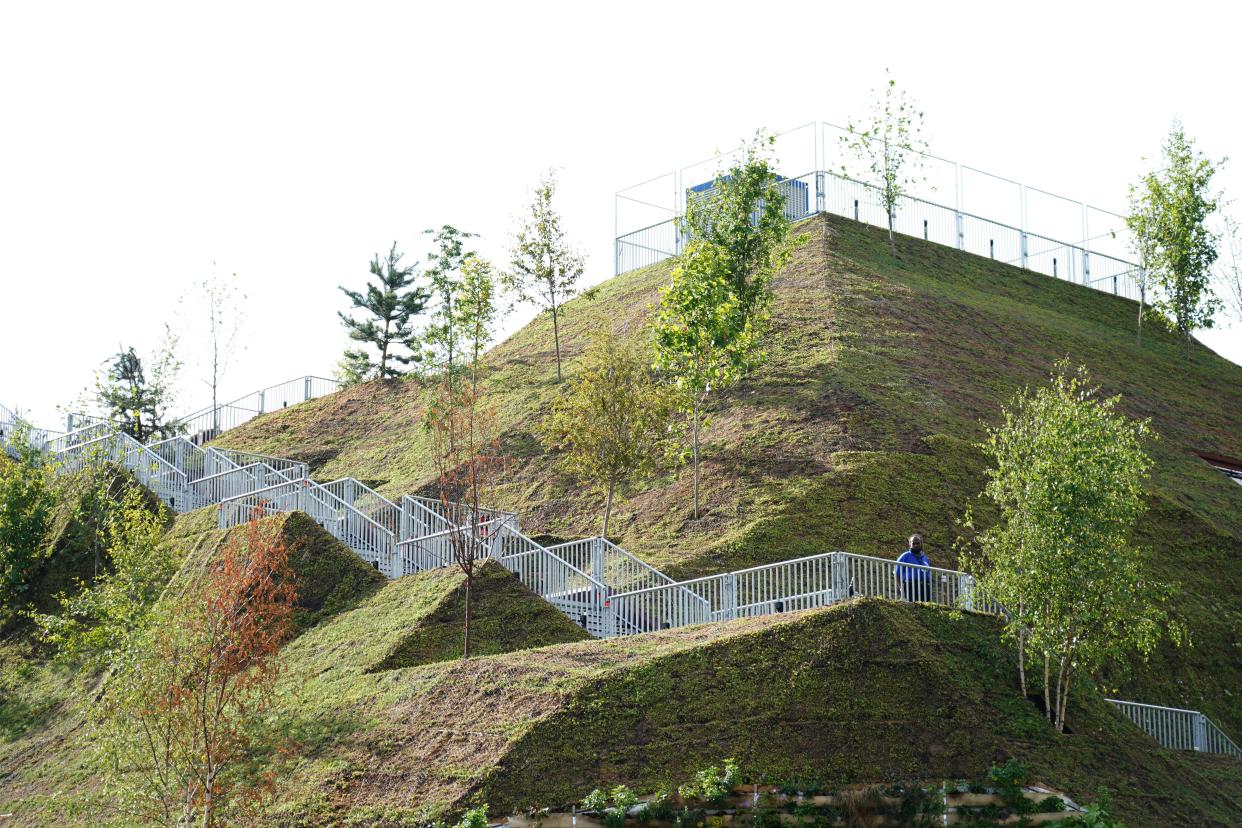 A steward and no visitors on the Marble Arch Mound in central London which has opened to the public. The summit of the new 25-metre high installation will provide sweeping views of Hyde Park, Mayfair and Marylebone when it opens to the public in July. The artificial hill has been built on a scaffolding base, with layers of soil and plywood forming the mound which has a hollow centre with space for exhibitions and displays. Picture date: Tuesday July 27, 2021. (PA Wire)