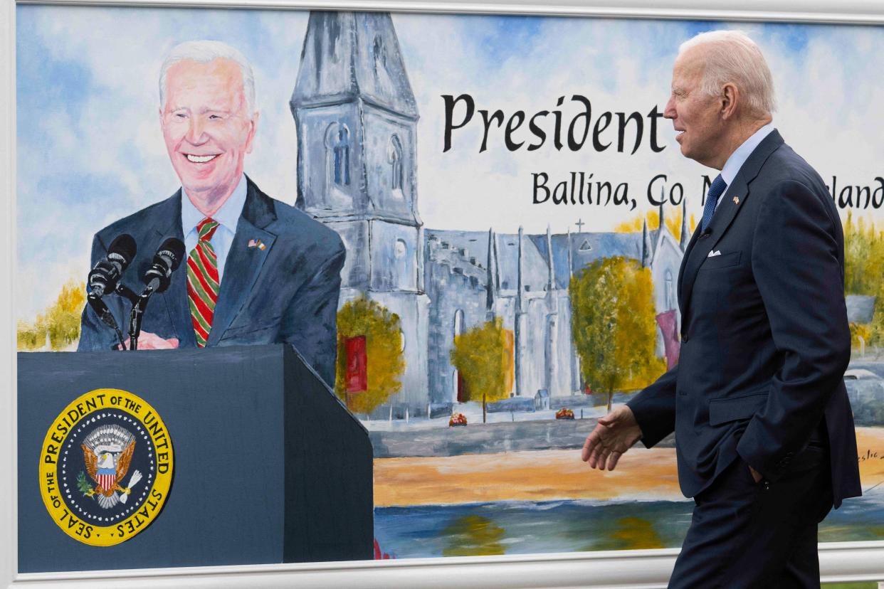 US President Joe Biden passes a painting on himself making a speech in front of the cathedral, while visiting the North Mayo Heritage Centre, near Ballina, on April 14, 2023, on the last day of a four day trip to Northern Ireland and Ireland. (Photo by Jim WATSON / AFP) (Photo by JIM WATSON/AFP via Getty Images)