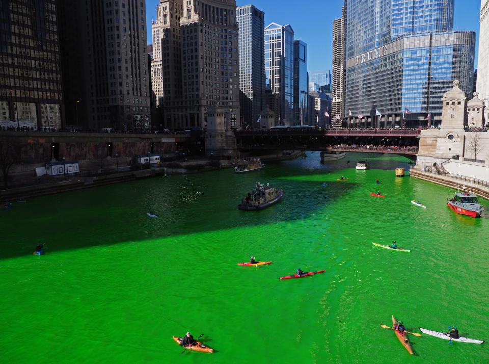 Mar 16, 2019; Chicago, IL, USA; Kayakers make their way up the Chicago River after the river was dyed green in celebration of St. Patrick's Day.