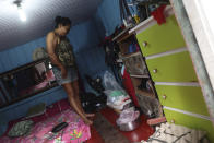 Noemia Ferreira Ribeiro stands on an elevated floor that was placed to avoid floodwater under her home in Anama, Amazonas state, Brazil, Thursday, May 13, 2021. (AP Photo/Edmar Barros)