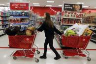 A woman pulls shopping carts through the aisle of a Target store on the shopping day dubbed "Black Friday" in Torrington, Connecticut November 25, 2011. REUTERS/Jessica Rinaldi