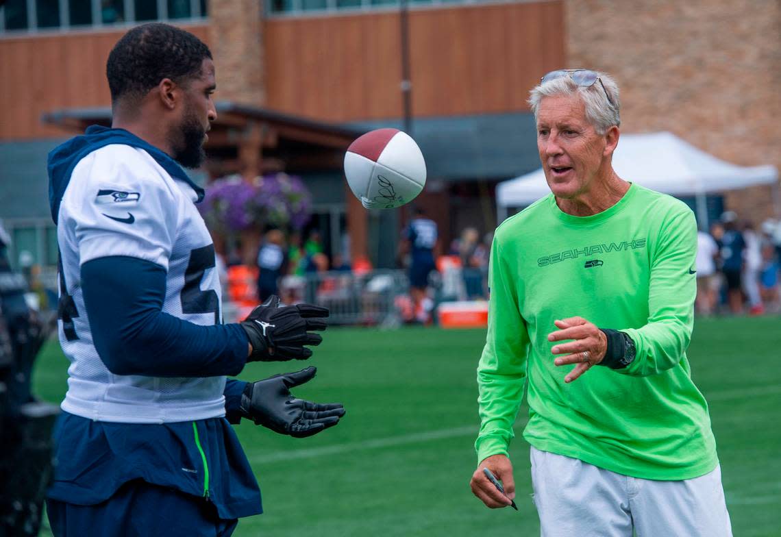 Seattle coach Pete Carroll gives a signed football for linebacker Bobby Wagner to throw to the fans on the third day of Seahawks training camp Saturday, July 31, 2021 at the VMAC in Renton.